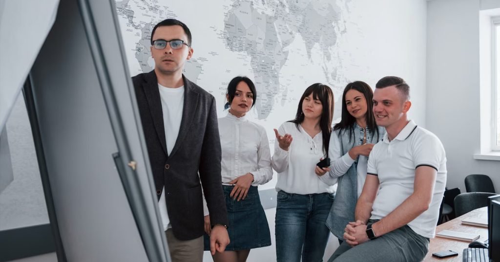 a group of people looking at the white board