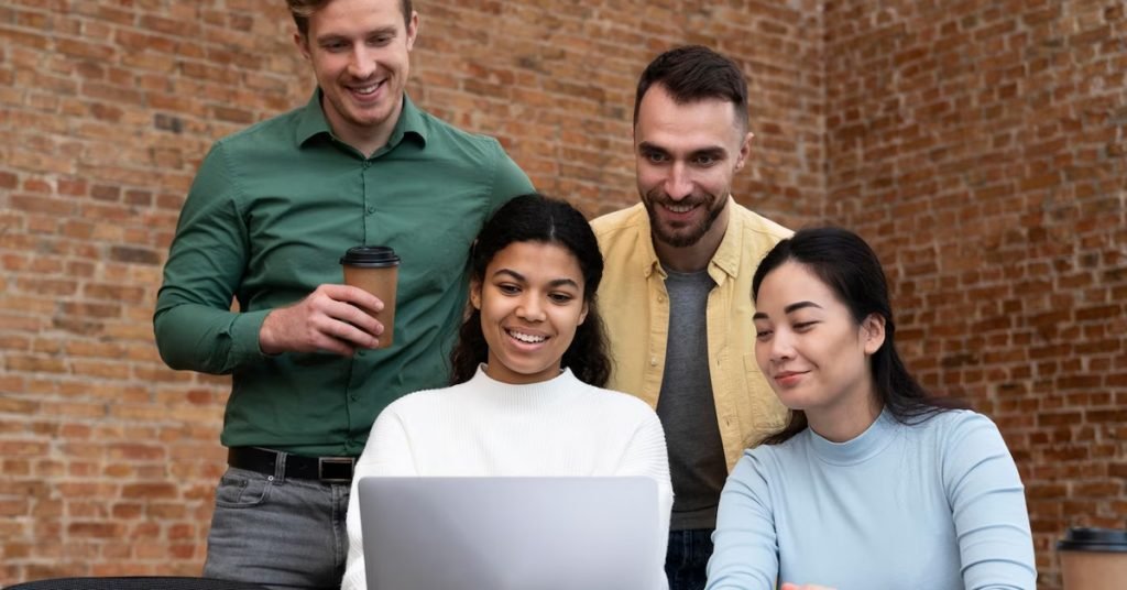 a group of peple looking at the laptop