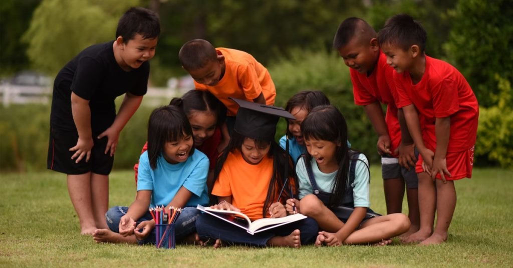 a group of children in a graduation cap and gown reading a book