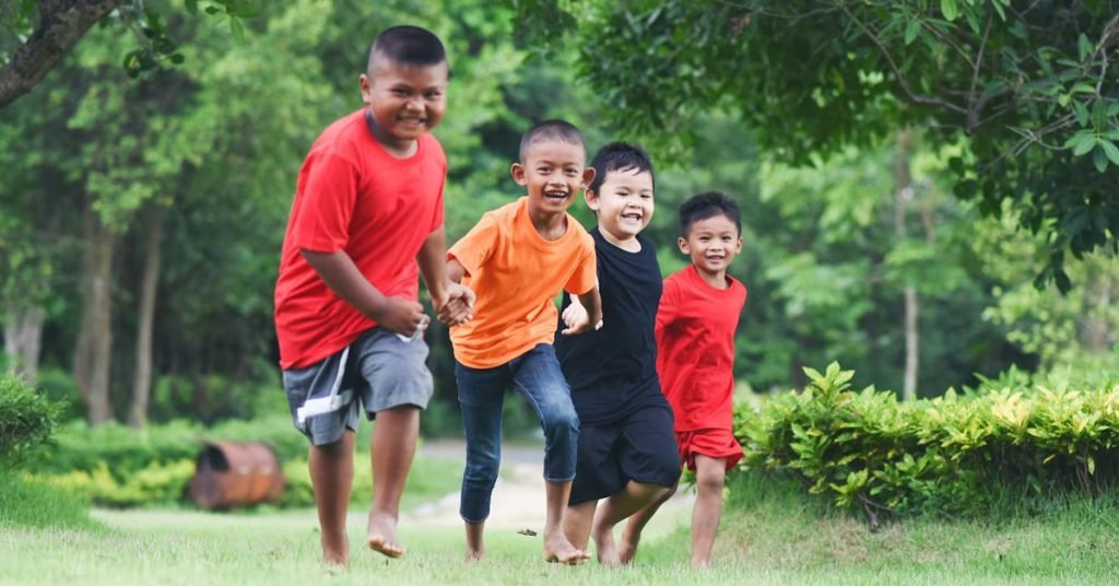 a group of children running in grass