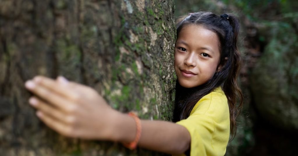 a girl hugging a tree