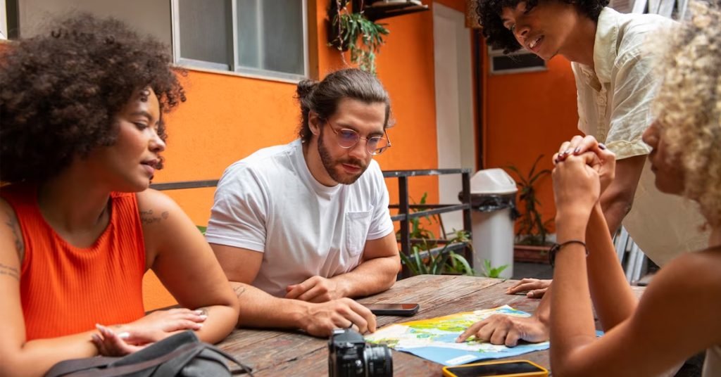 a group of people sitting at a table looking at a map