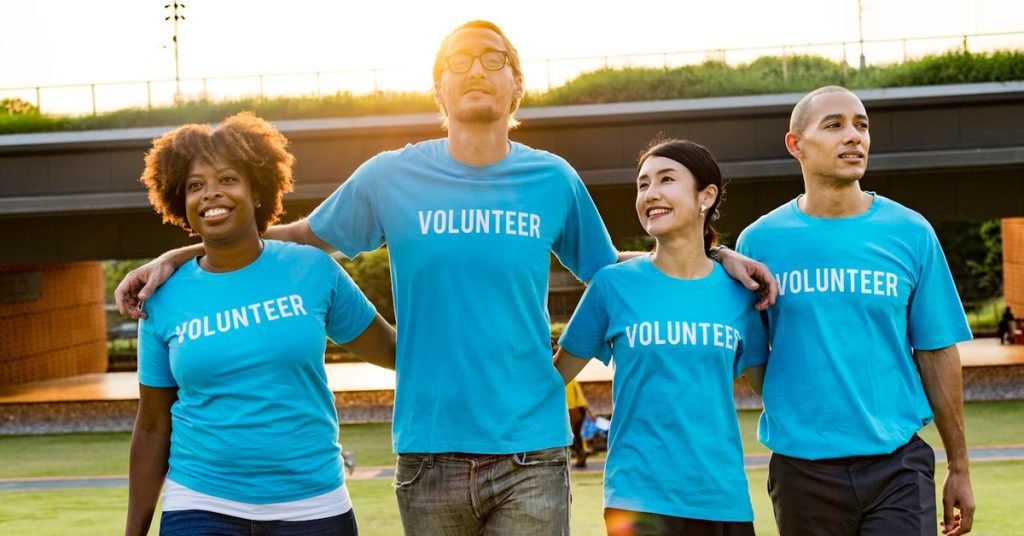 a group of people wearing blue shirts written volunteer on it