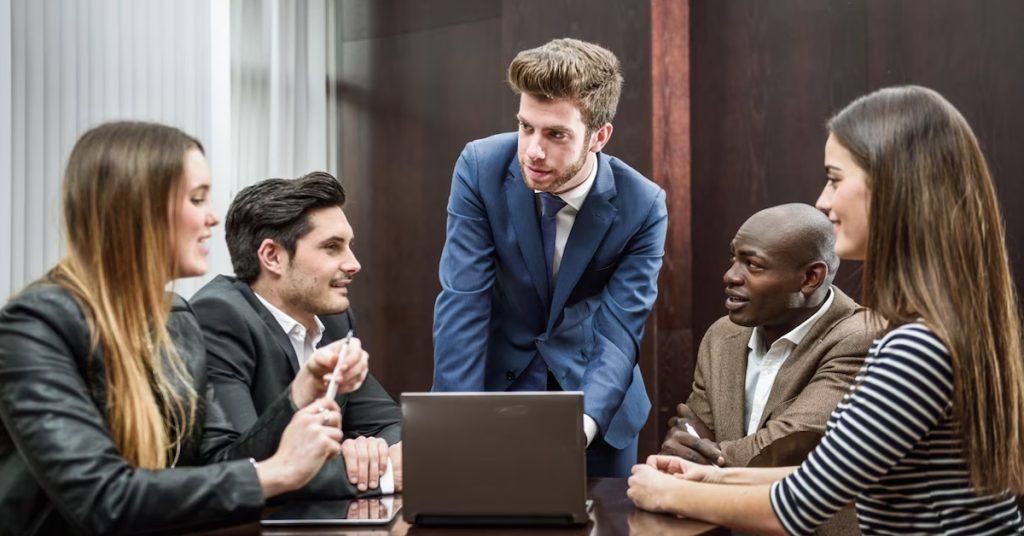 a group of people sitting around a table in a meeting