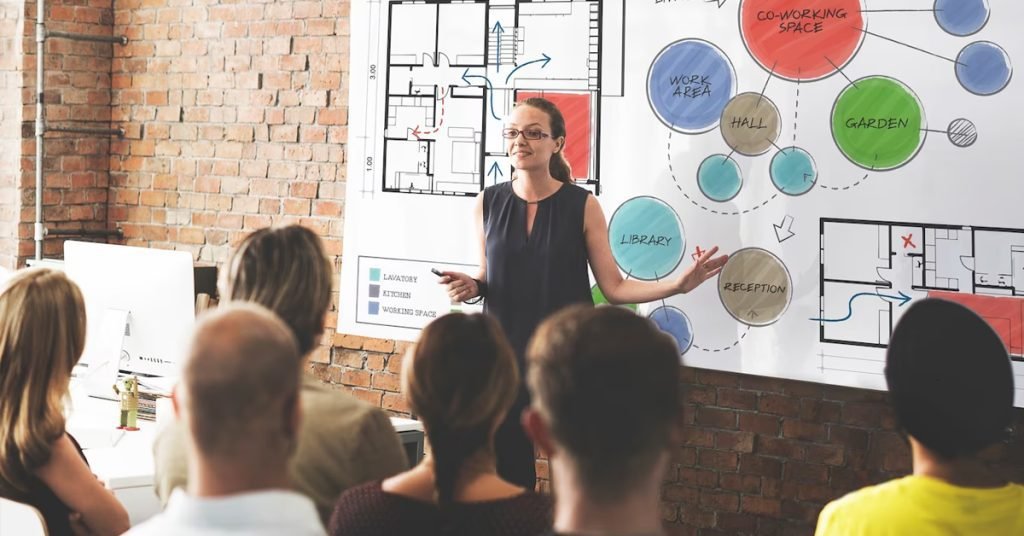 a woman standing in front of a whiteboard explaining the home plan