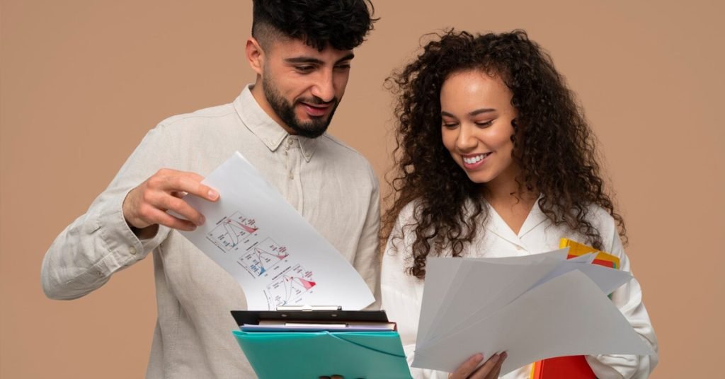 a man and woman looking at papers