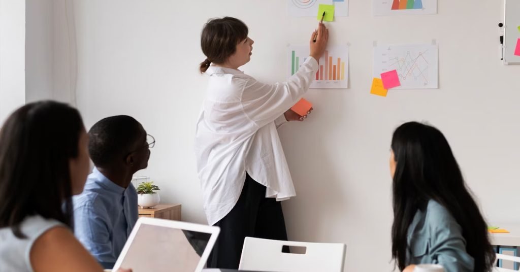 a woman writing on a white board