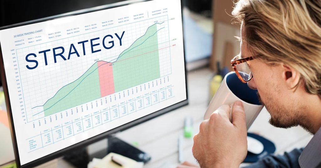 a man drinking a coffee while looking at a graph with headline written as strategy