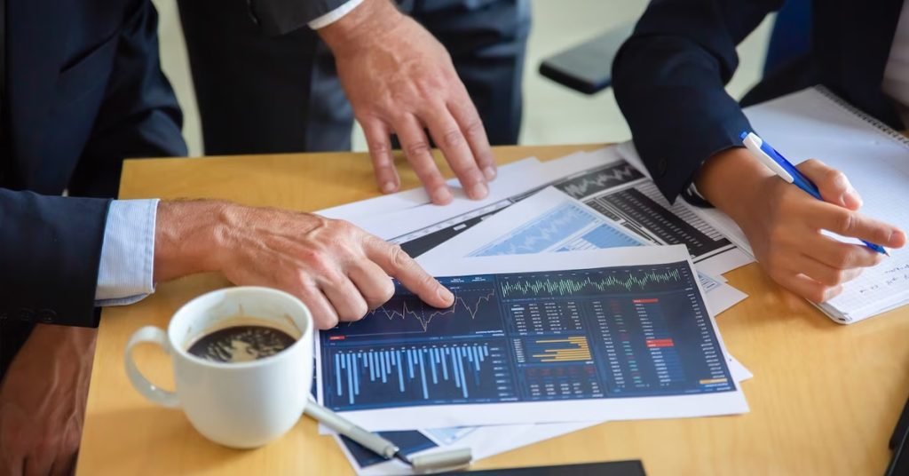 a man pointing at a graph on a paper