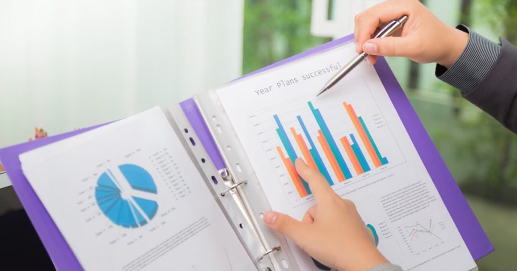 Pair of hands pointing on a graph