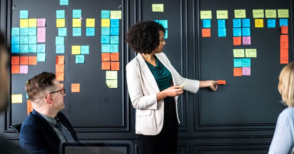 a woman standing next to a wall with post-it notes