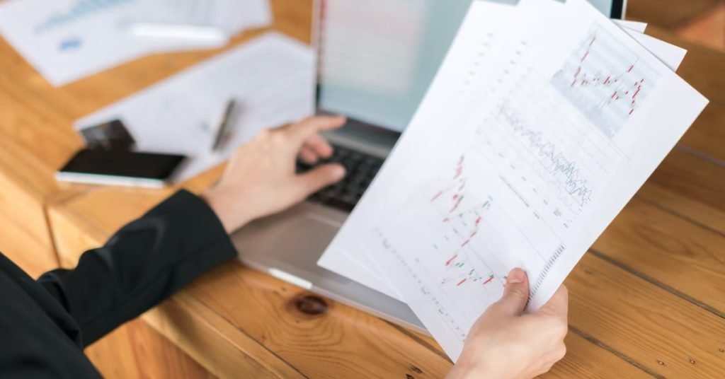 a close-up of hands pointing at a graph