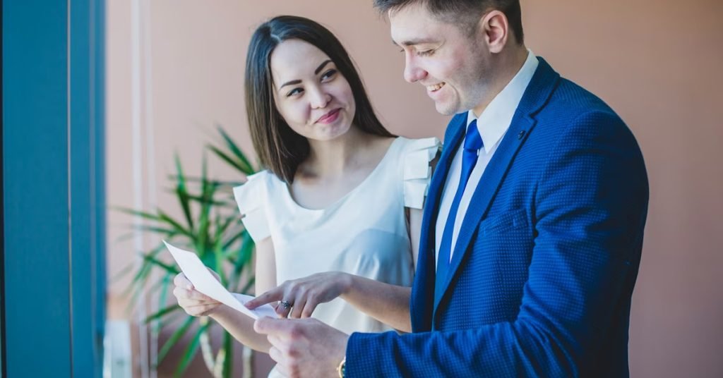 a man and woman looking at a piece of paper