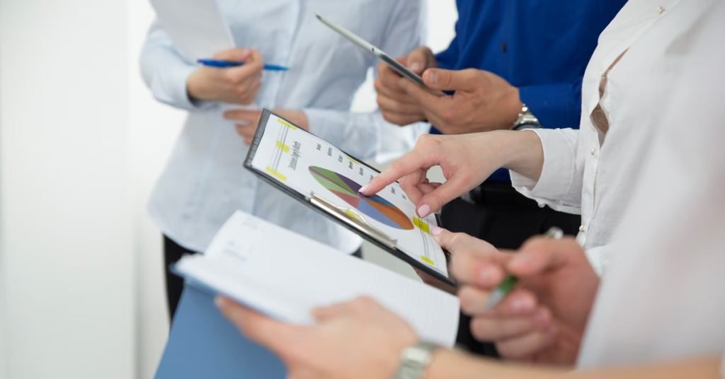 a group of people holding a clipboard