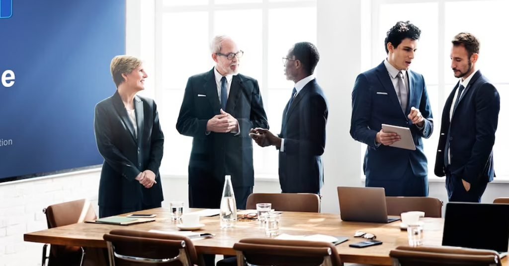 a group of people in suits standing around a table