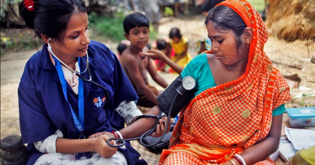 Doctor checking the blood pressure of the women