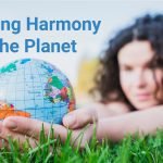an girl holding a globe signifying Auroville & SDGs support for the planet