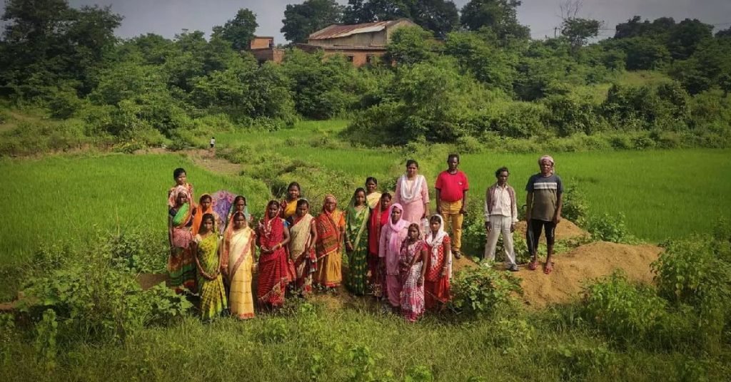 a group of people standing in a field